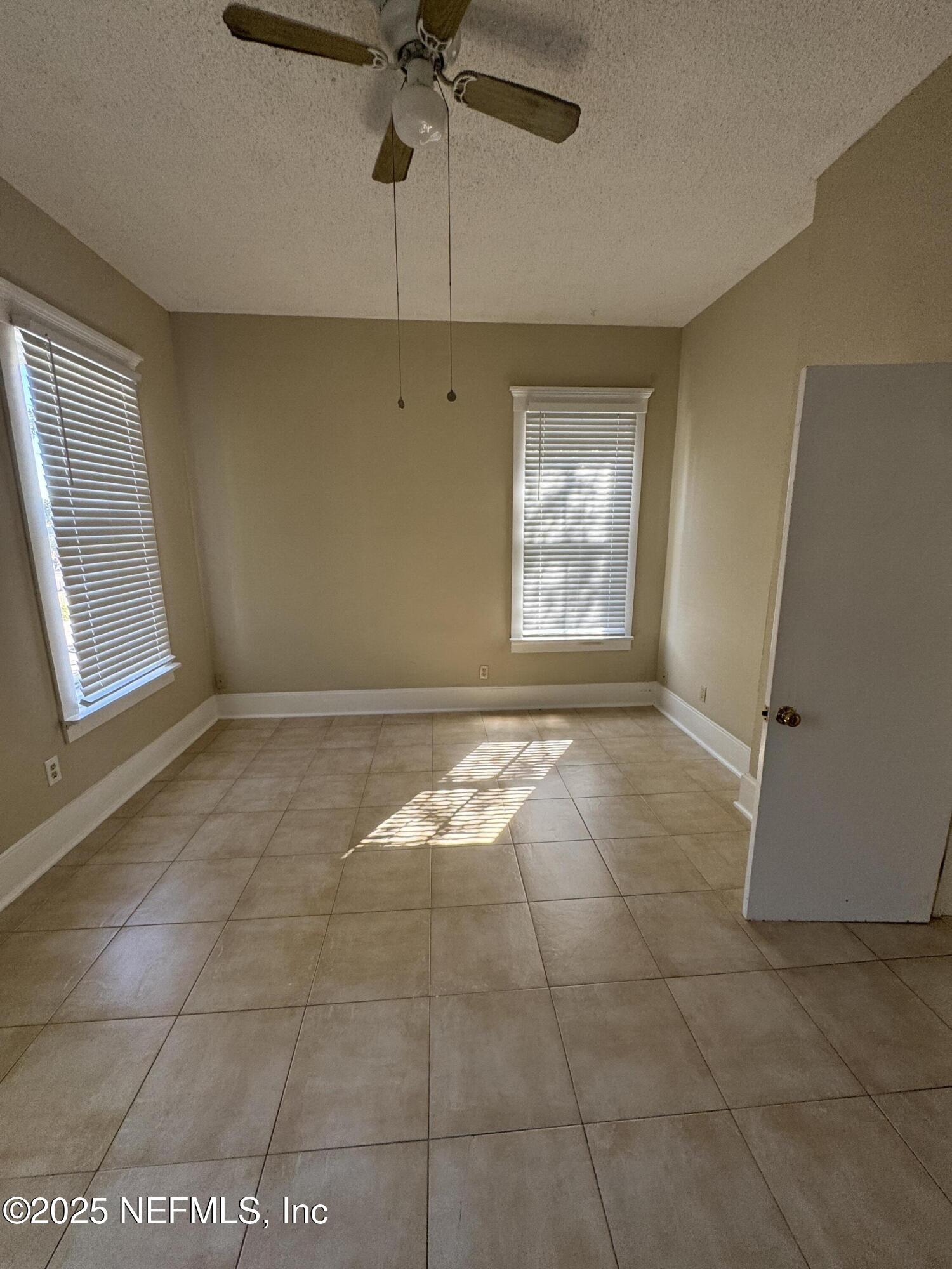 1604 Cherry Street, Unit 4 Jacksonville, FL 32205 - Photo 9 of 11 an empty room with windows and fan