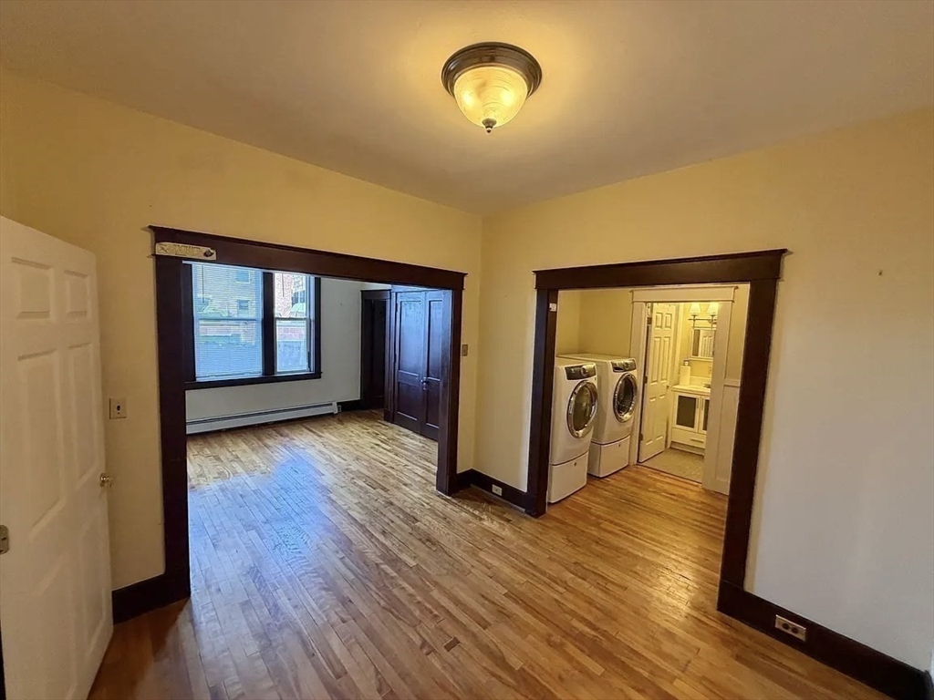 27 High Street, Unit 1 Clinton, MA 01510 - Photo 12 of 30 wooden floor in an empty room with a window