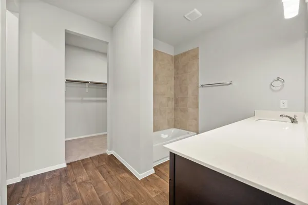a bathroom with a double vanity sink and a mirror