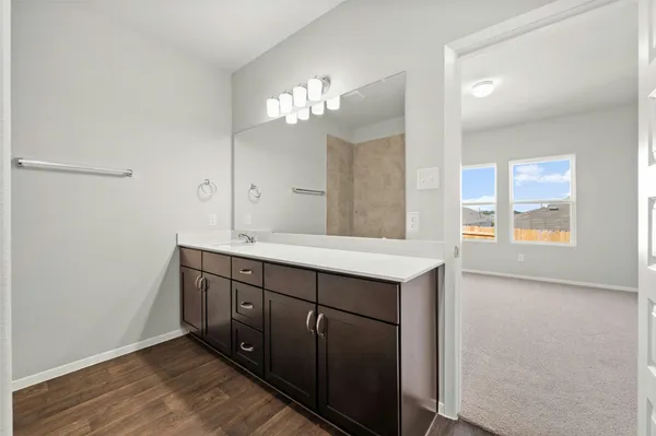 a bathroom with a tub shower and vanity