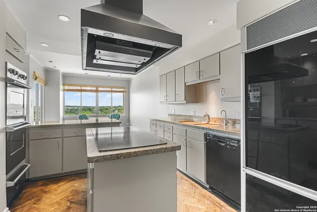 a kitchen with stainless steel appliances a sink stove and refrigerator
