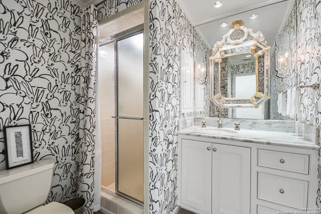 a bathroom with a double vanity sink mirror and