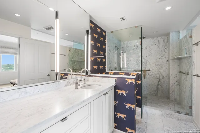 a bathroom with a sink double vanity and a shower