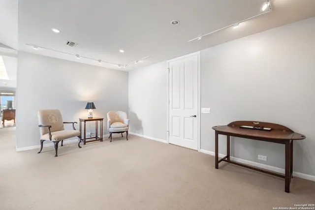 a living room with furniture and a lamp
