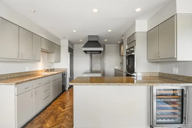 a kitchen with stainless steel appliances granite countertop a sink and cabinets