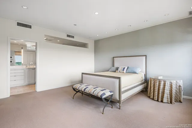 a bedroom with a bed and a lamp