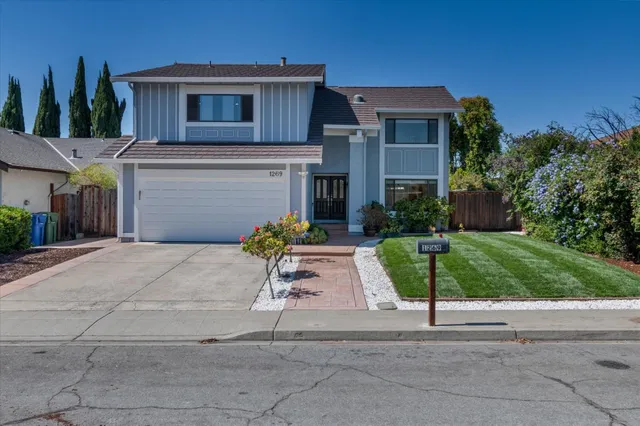 a front view of a house with a yard and garage