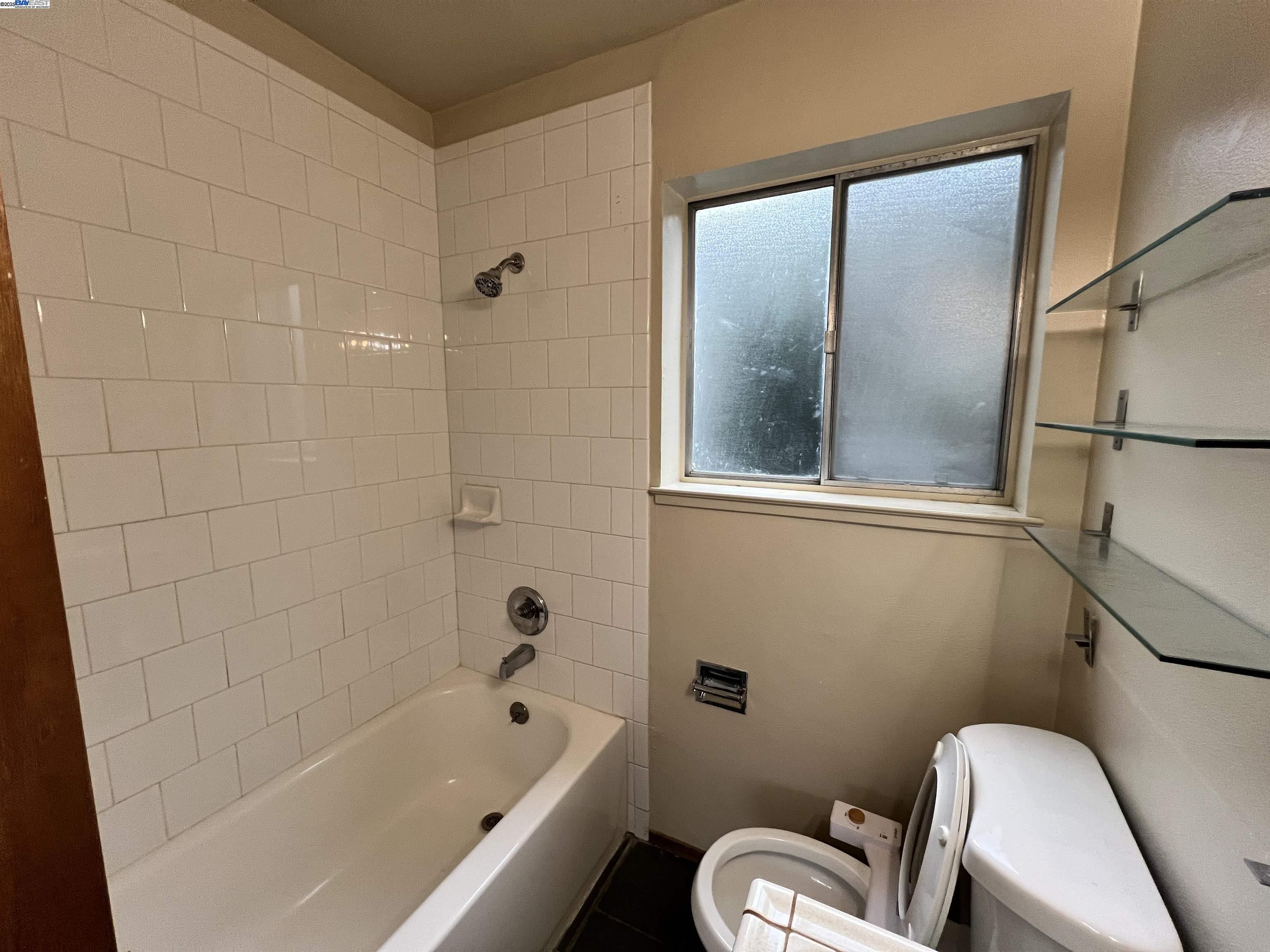 2418 Ashby Avenue, Unit B Berkeley, CA 94705 - Photo 14 of 14 a bathroom with a toilet and a bathtub