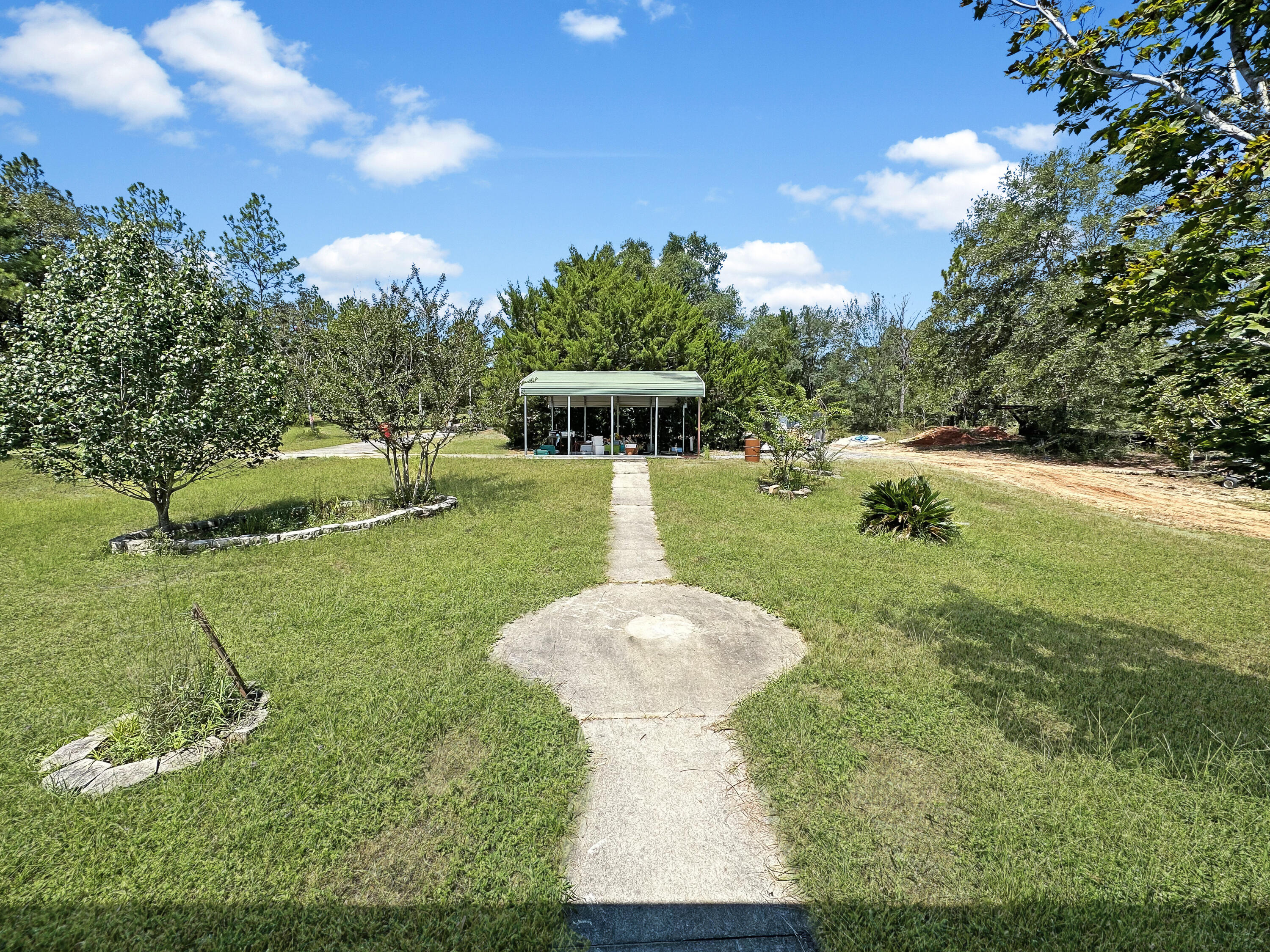 6119 Clear Creek Road Crestview, FL 32539 - Photo 13 of 46 a view of a garden with large trees