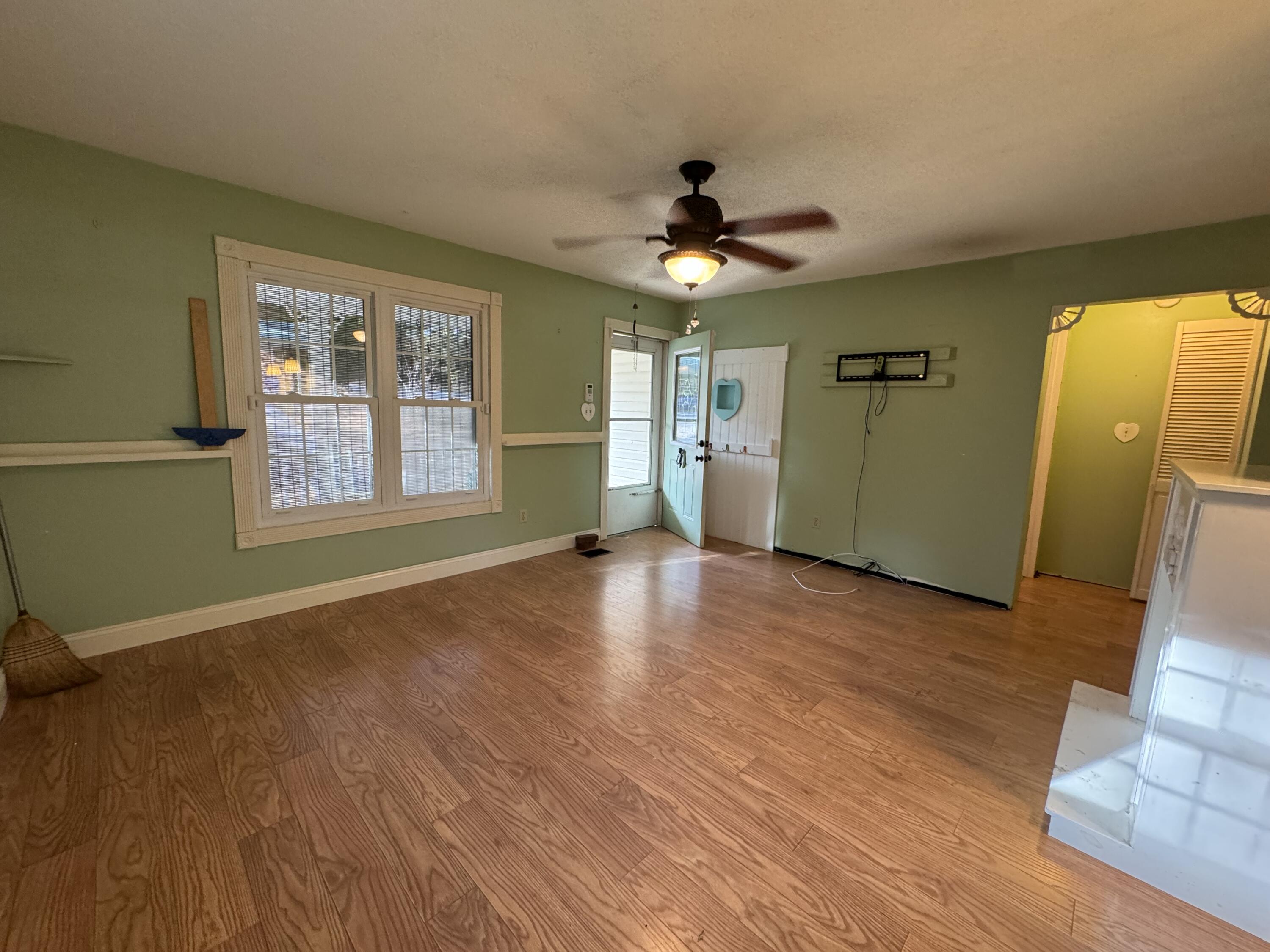 6119 Clear Creek Road Crestview, FL 32539 - Photo 2 of 46 a view of an empty room with window and wooden floor