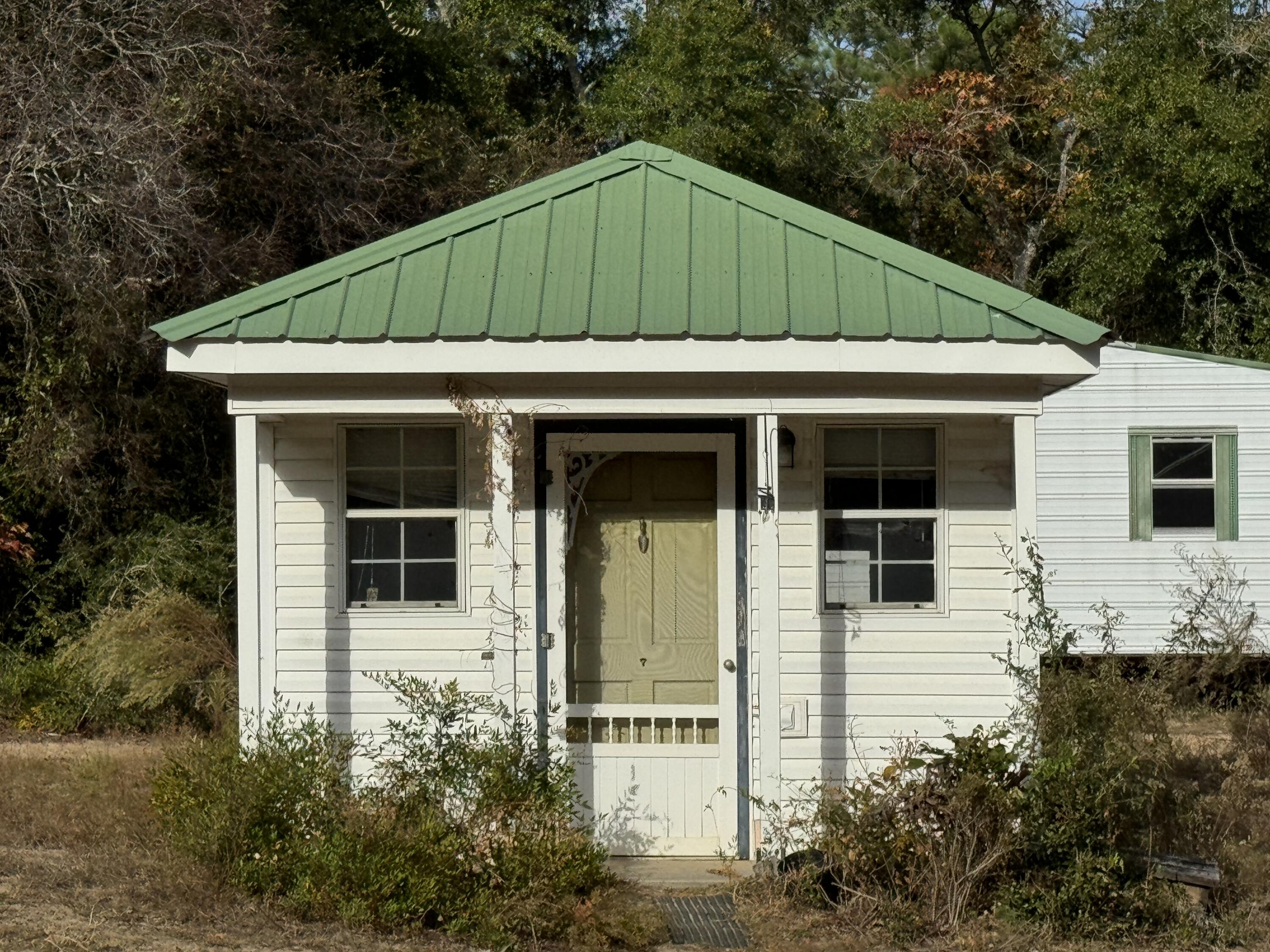 6119 Clear Creek Road Crestview, FL 32539 - Photo 23 of 46 a front view of a house with garden