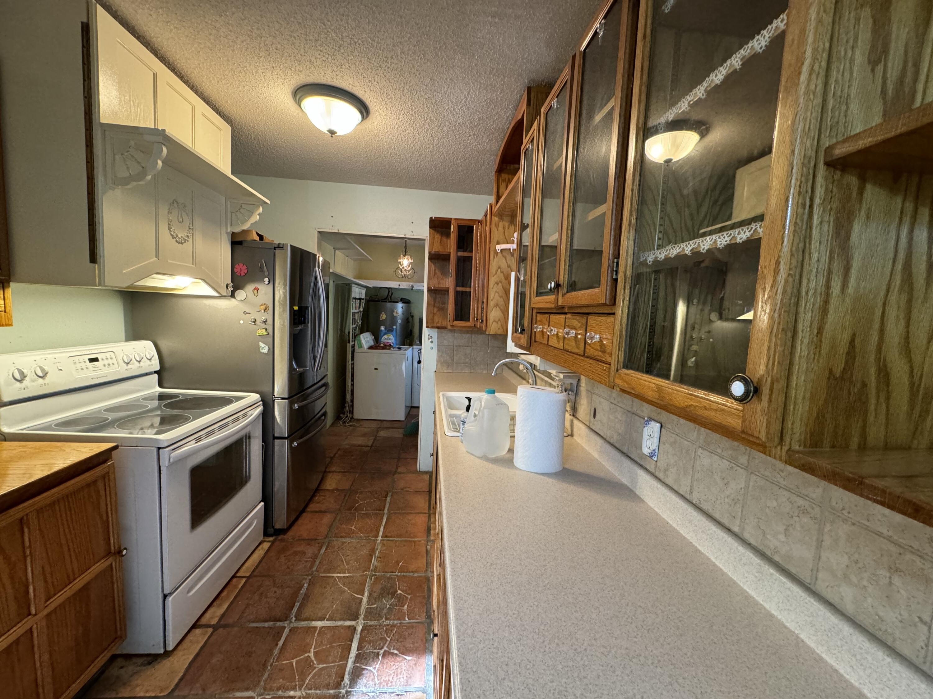 6119 Clear Creek Road Crestview, FL 32539 - Photo 33 of 46 a kitchen with stainless steel appliances granite countertop a sink and a refrigerator