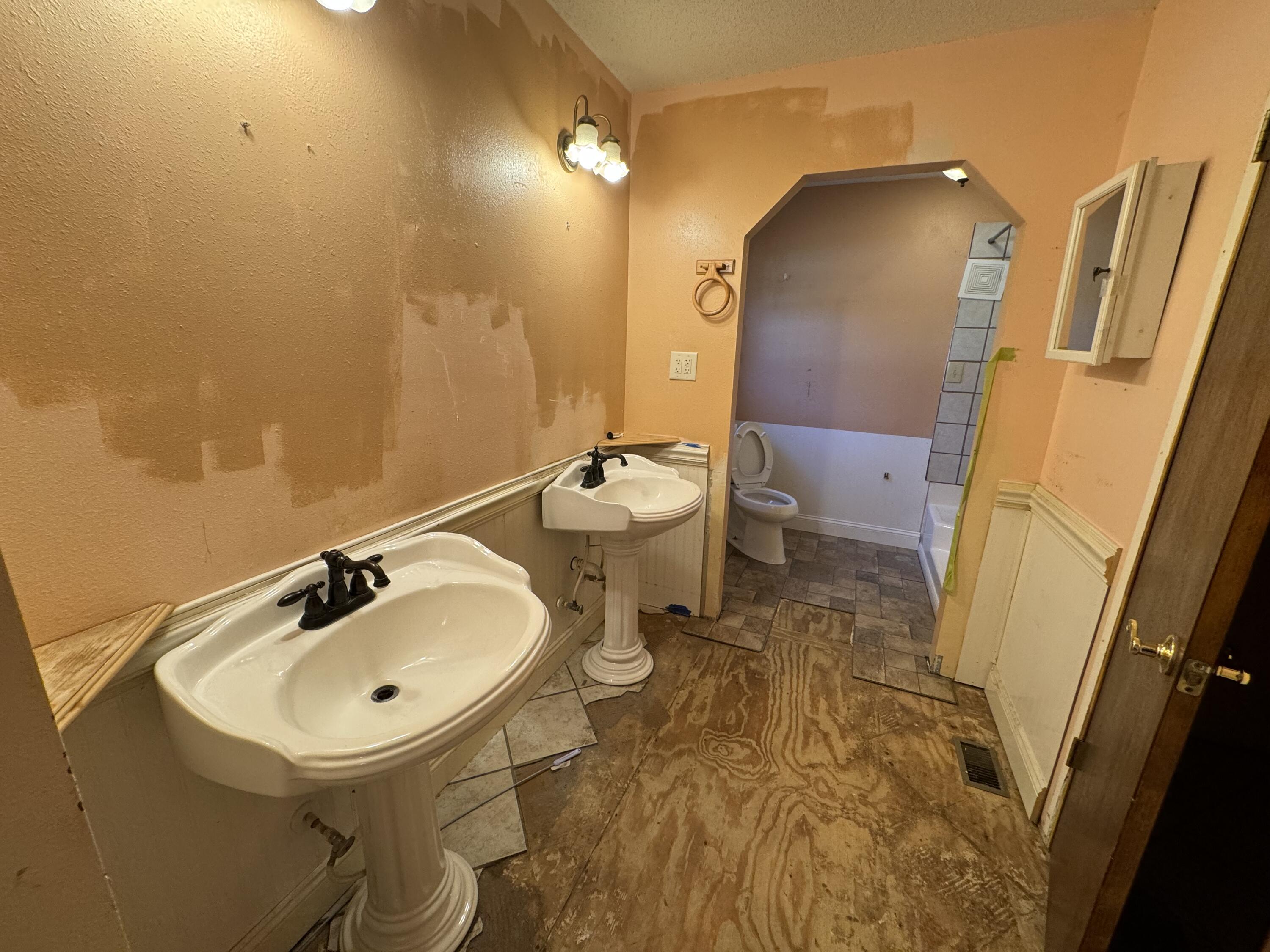 6119 Clear Creek Road Crestview, FL 32539 - Photo 40 of 46 a bathroom with a sink and mirror with toilet