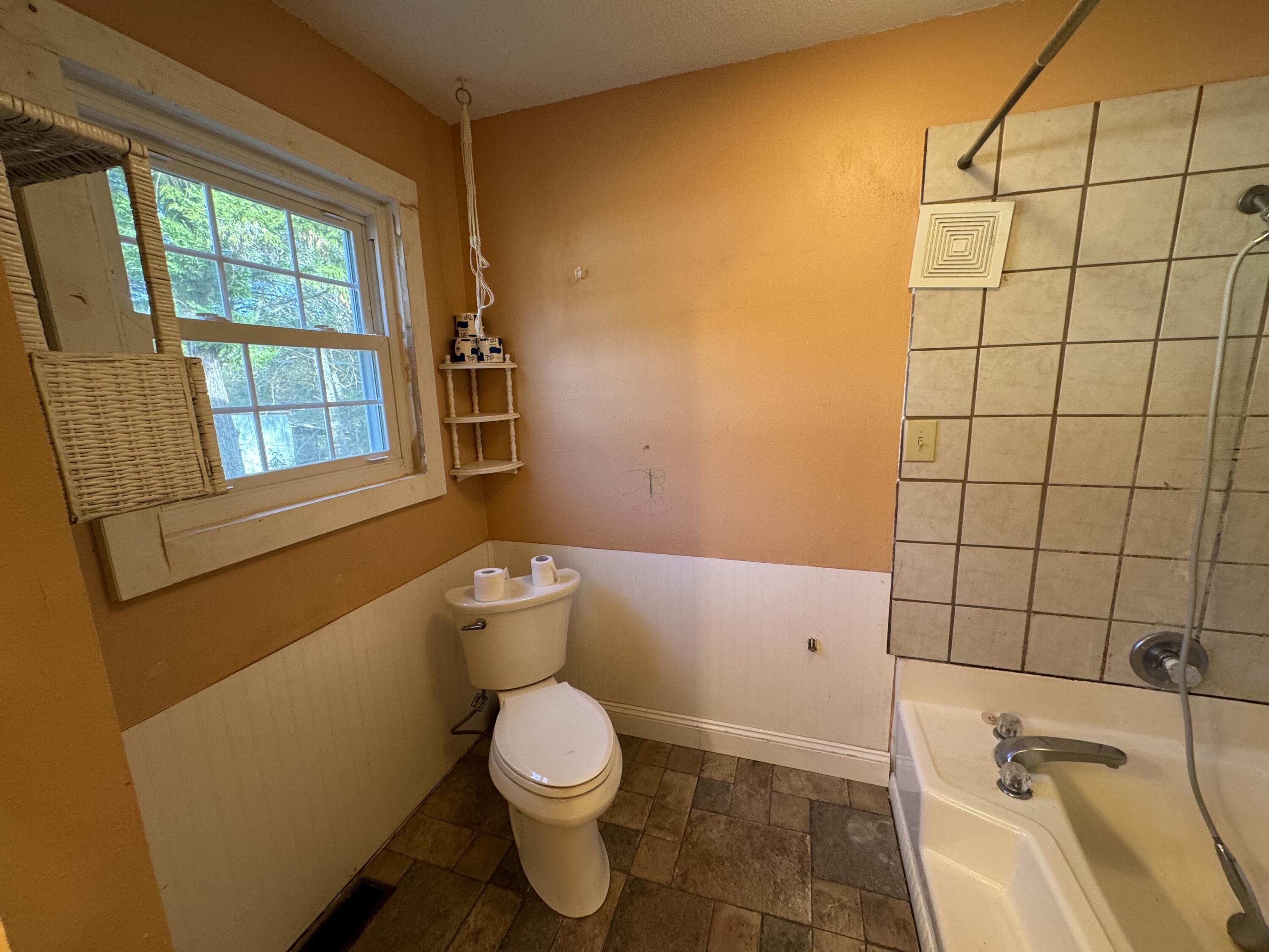6119 Clear Creek Road Crestview, FL 32539 - Photo 42 of 46 a white toilet sitting next to a bathroom sink and tub
