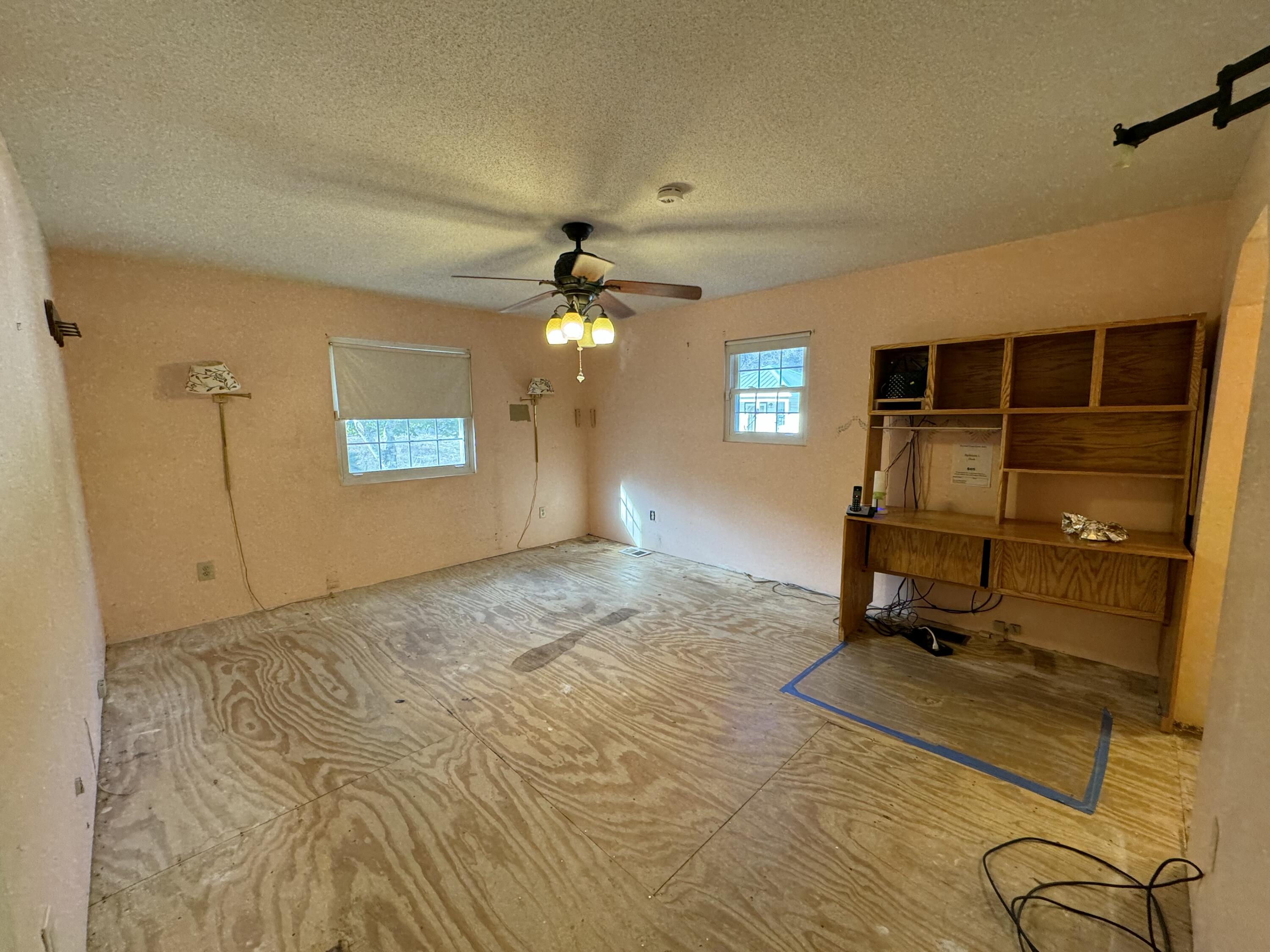 6119 Clear Creek Road Crestview, FL 32539 - Photo 5 of 46 a view of a livingroom with chairs and a flat screen tv
