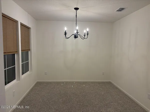 a kitchen with refrigerator and microwave