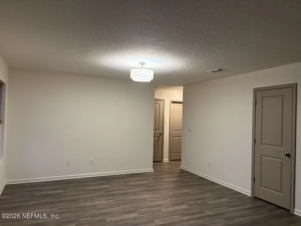 a bathroom with a granite countertop toilet a sink and a mirror