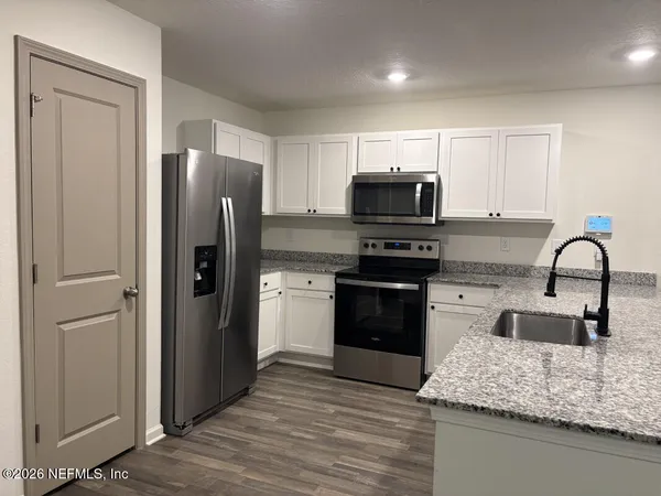 an empty room with a ceiling fan and a window
