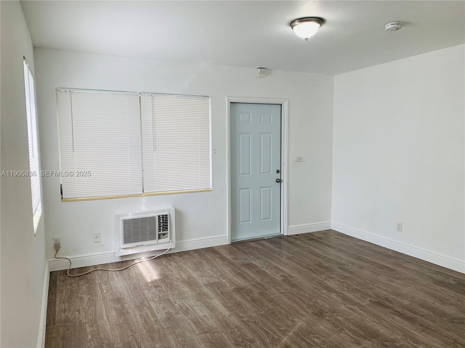 738 Northeast 86th Street, Unit 8 Miami, FL 33138 - Photo 4 of 9 a view of an empty room with wooden floor