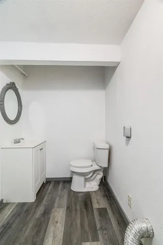 a bathroom with a sink toilet and a mirror