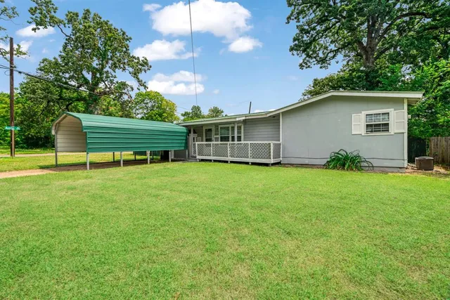 a backyard of a house with table and chairs