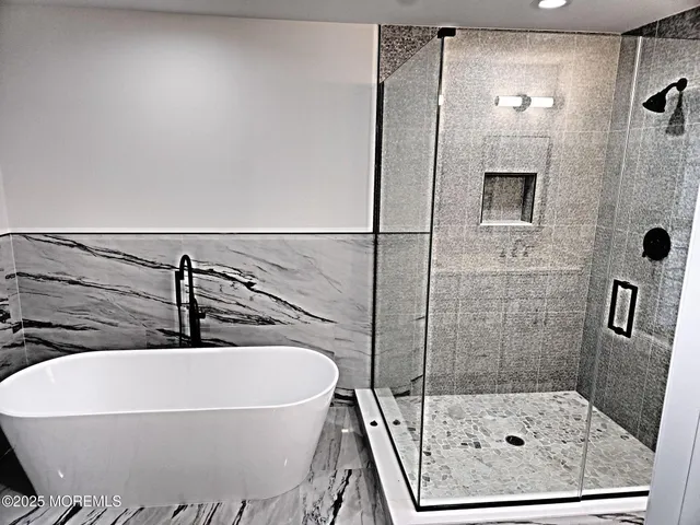 a bathroom with a bathtub and shower