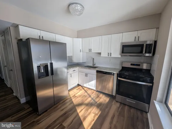 a kitchen with stainless steel appliances and a refrigerator