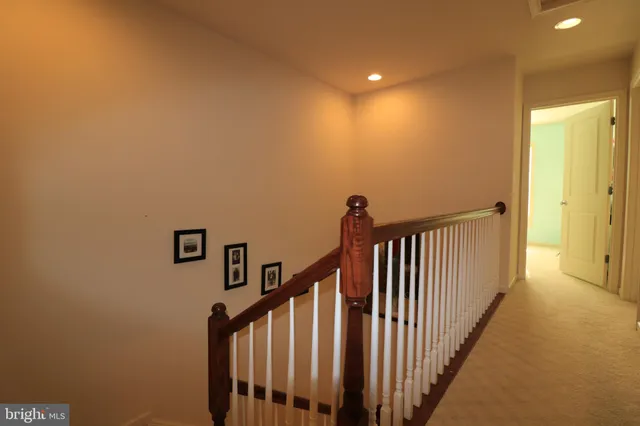 a view of staircase with railing and a window