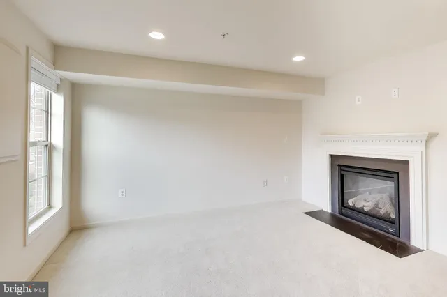 a view of an empty room with a fireplace