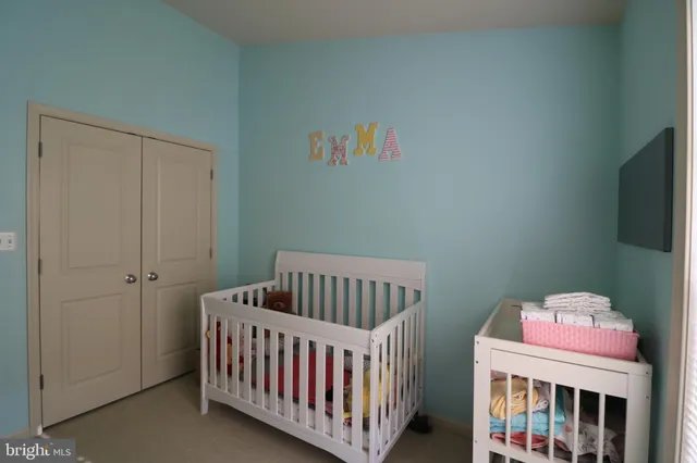 a bedroom with furniture and a baby crib
