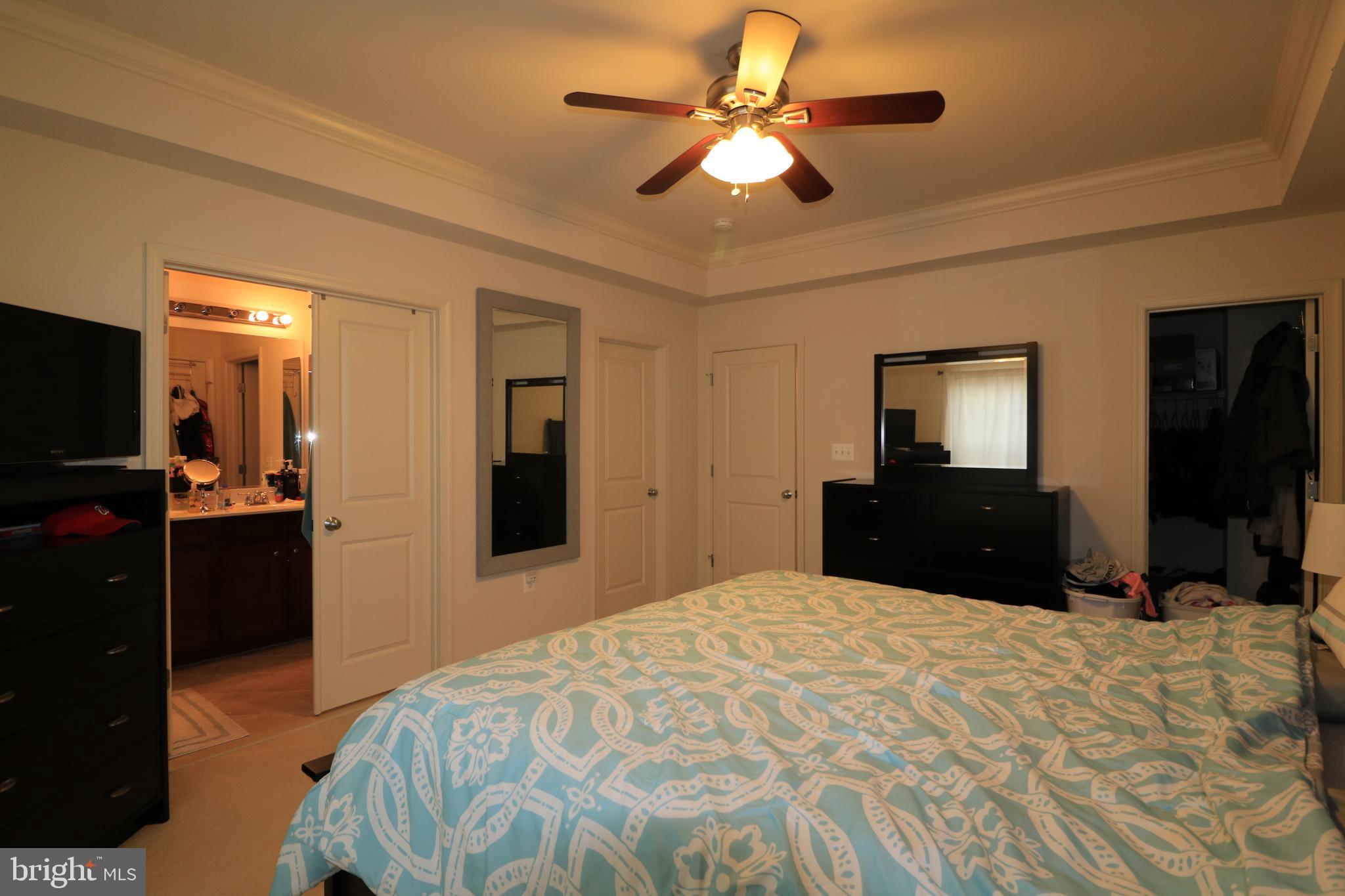 13411 Deer Highlands Way Silver Spring, MD 20906 - Photo 15 of 32 a bedroom with a bed and a flat tv screen on dresser