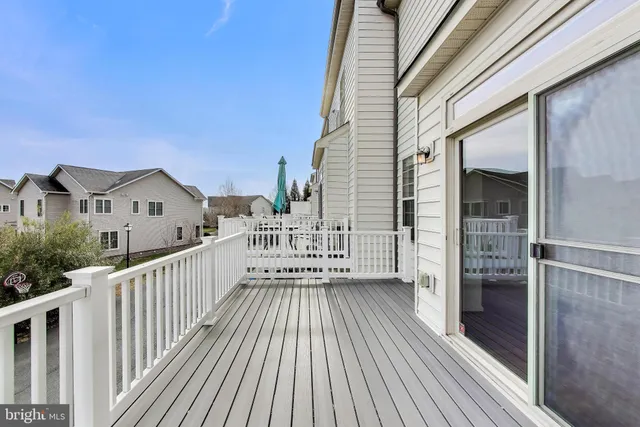 a view of a house with wooden deck