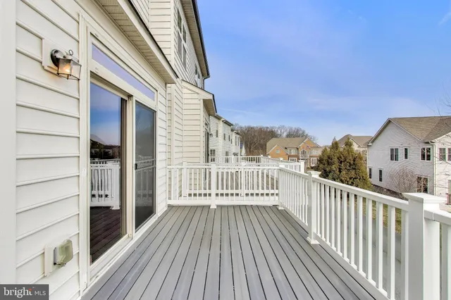 a view of a balcony with wooden floor and fence