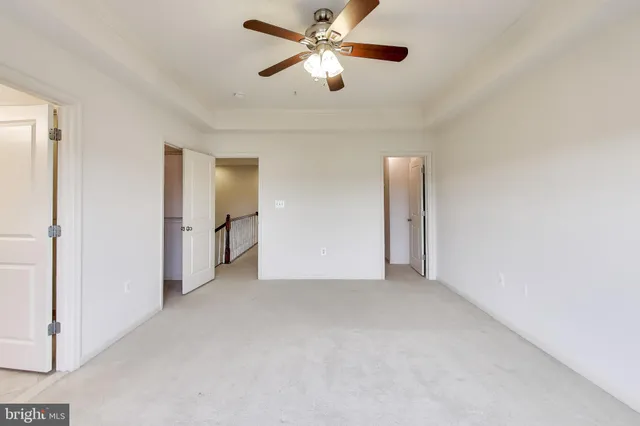 a view of a livingroom with a ceiling fan and window