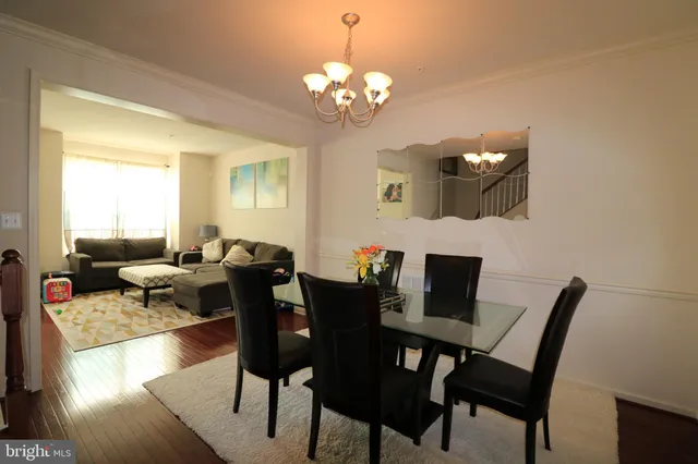 a view of a dining room with furniture and chandelier