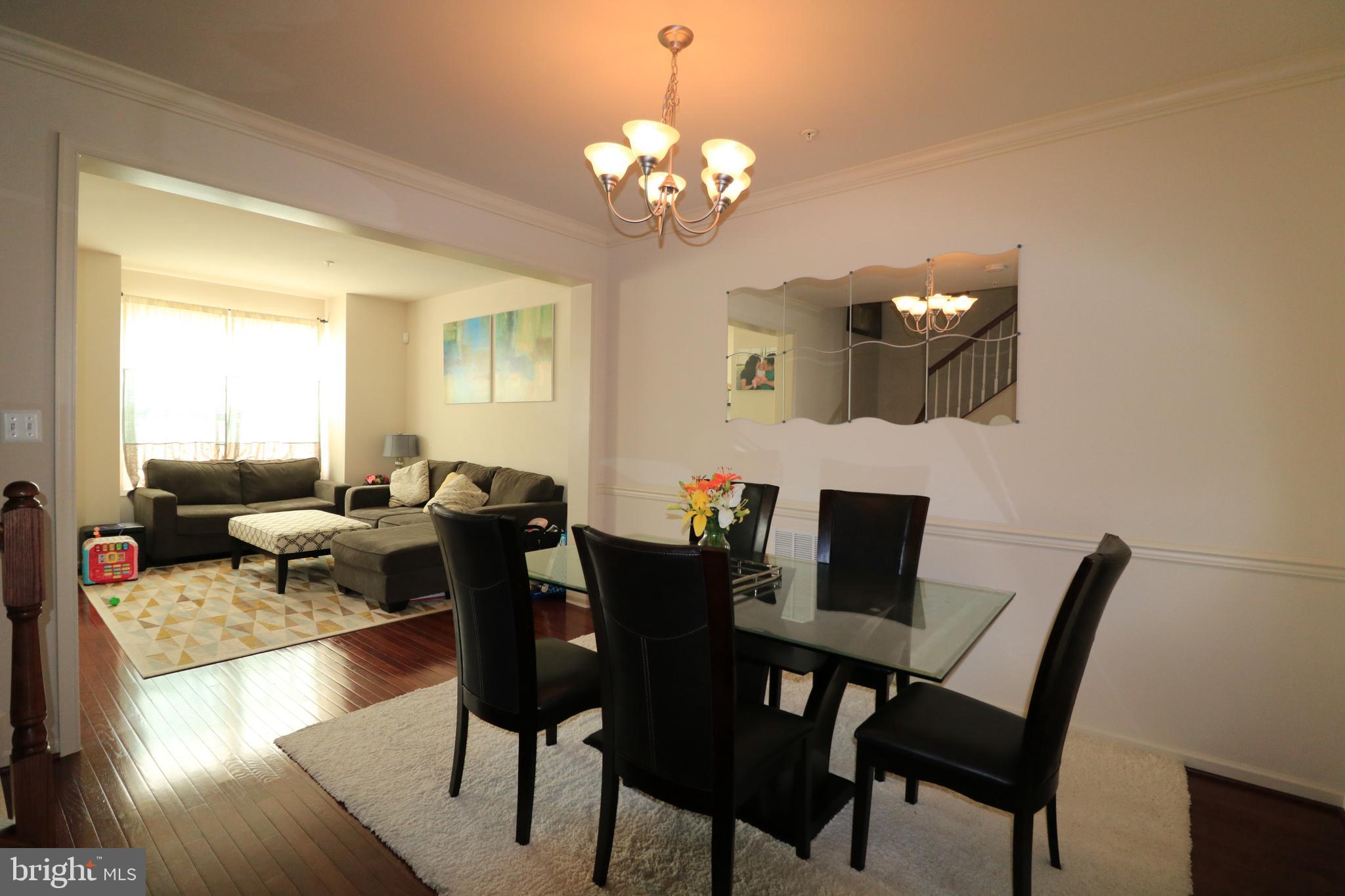 13411 Deer Highlands Way Silver Spring, MD 20906 - Photo 6 of 32 a view of a dining room with furniture and chandelier