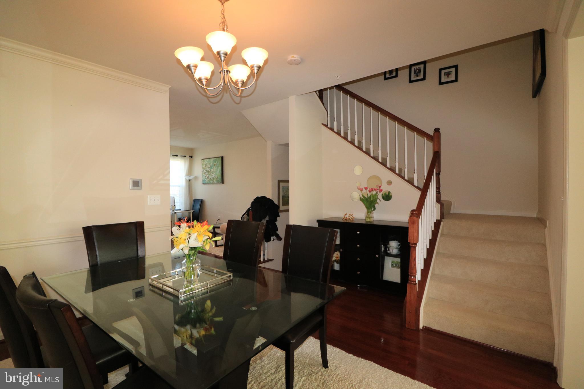 13411 Deer Highlands Way Silver Spring, MD 20906 - Photo 7 of 32 a view of a dining room with furniture and wooden floor