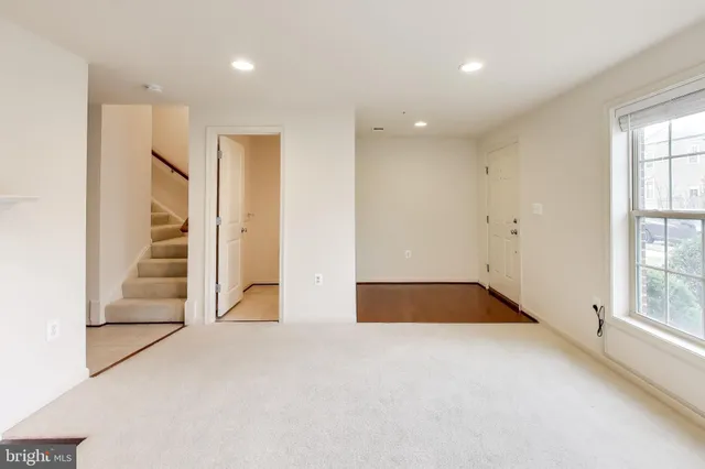 an empty room with a en suite bathroom and a window