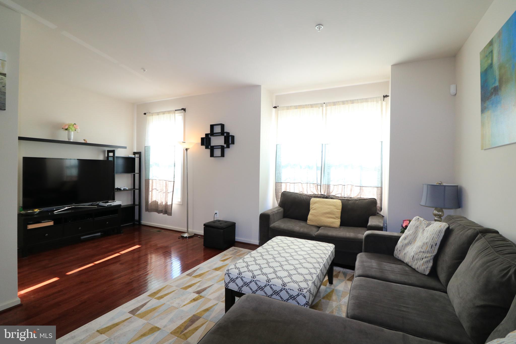 13411 Deer Highlands Way Silver Spring, MD 20906 - Photo 9 of 32 a living room with furniture and a flat screen tv