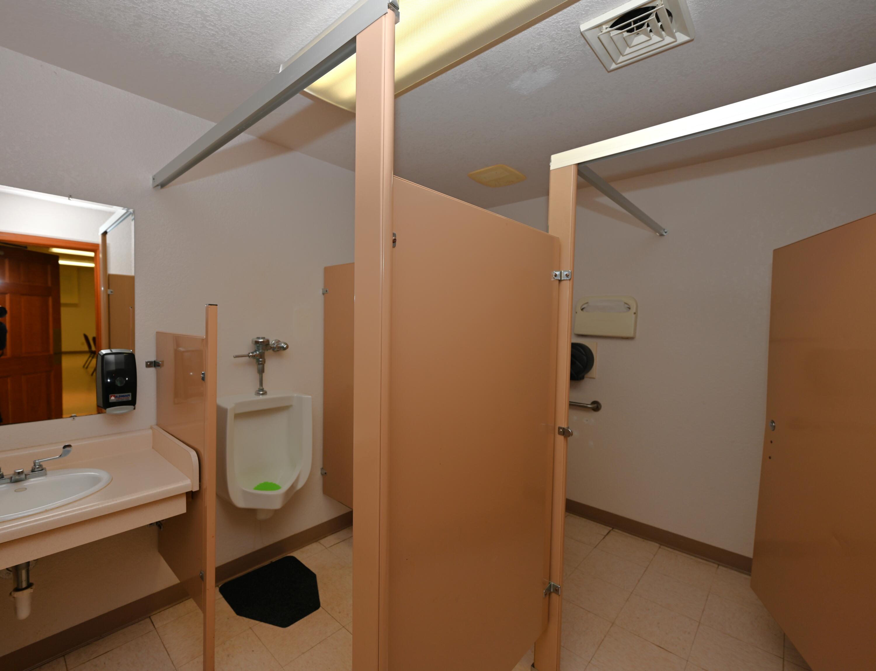 340 East 50 North Winamac, IN 46996 - Photo 21 of 38 a bathroom with a sink mirror and toilet