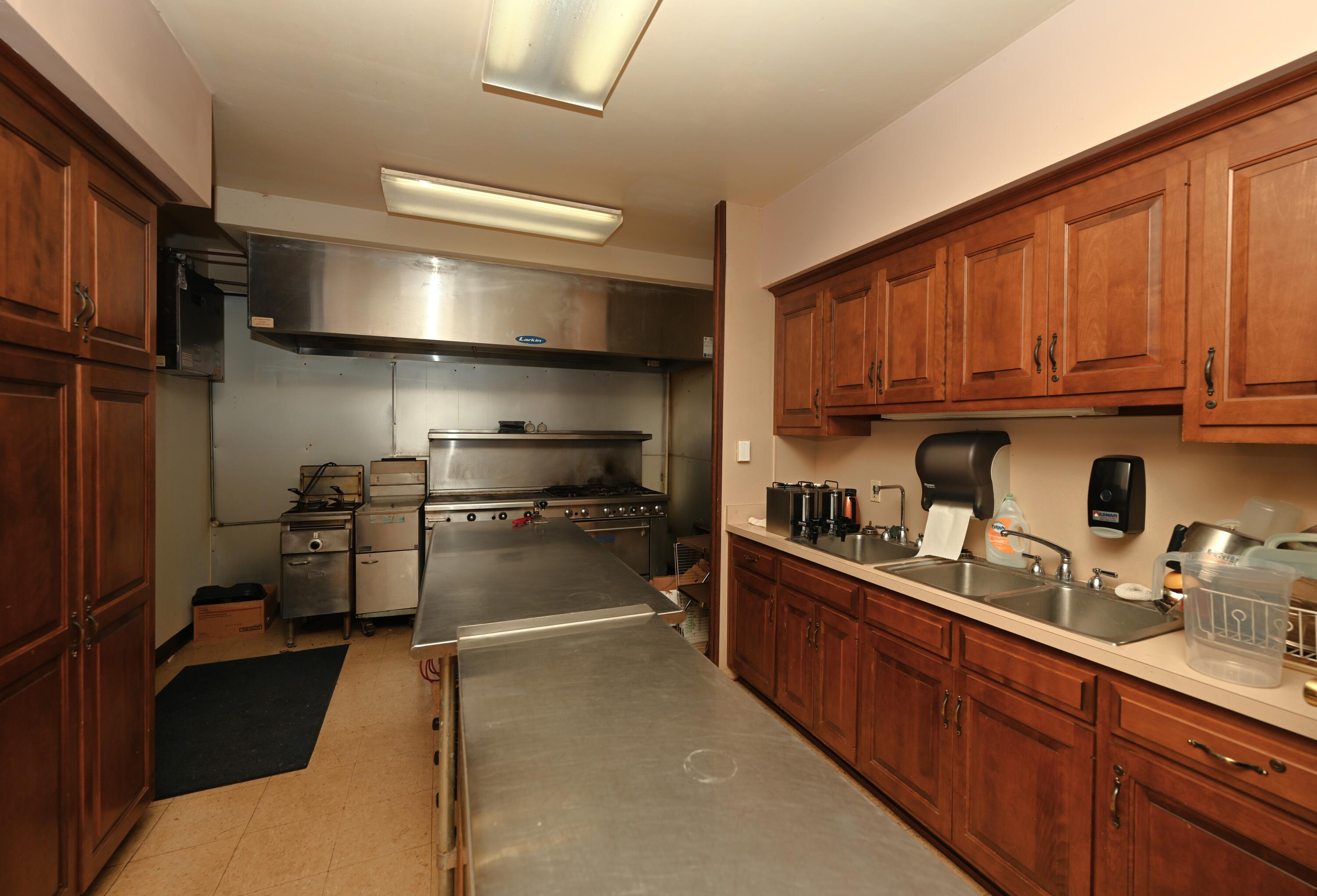 340 East 50 North Winamac, IN 46996 - Photo 25 of 38 a kitchen with stainless steel appliances wooden cabinets and a stove top oven