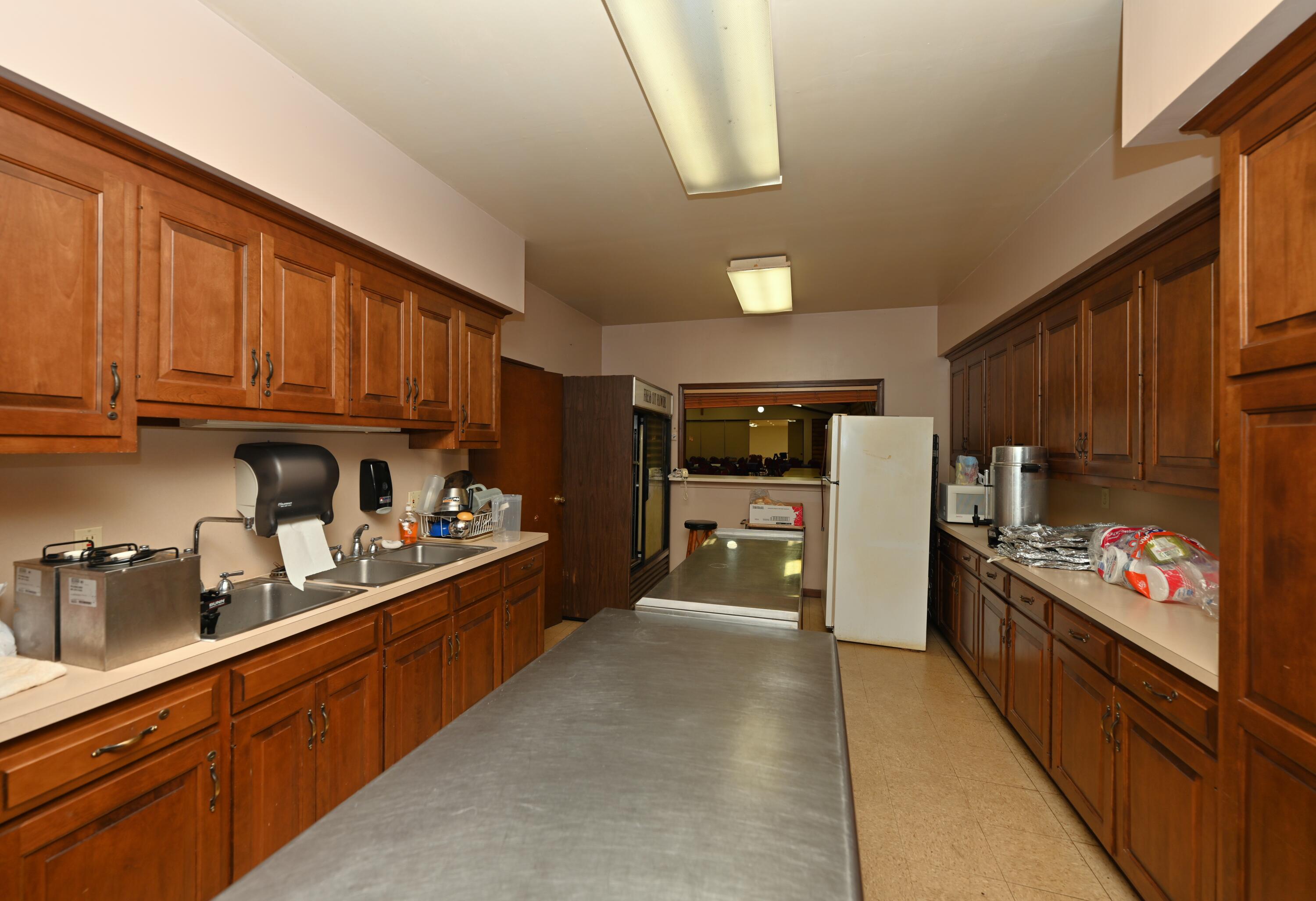 340 East 50 North Winamac, IN 46996 - Photo 26 of 38 a kitchen with stainless steel appliances wooden cabinets and a stove top oven