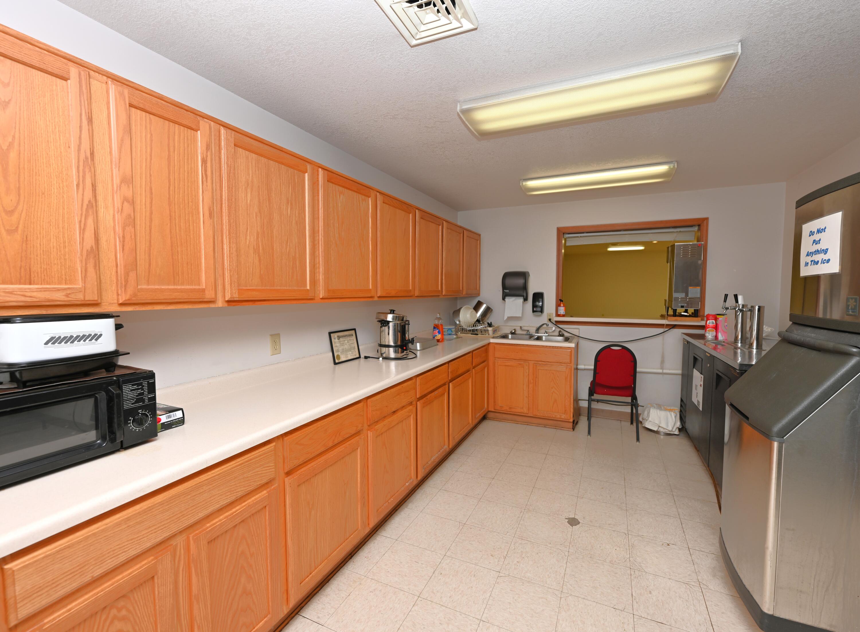 340 East 50 North Winamac, IN 46996 - Photo 35 of 38 a large kitchen with stainless steel appliances granite countertop a sink dishwasher stove and cabinets