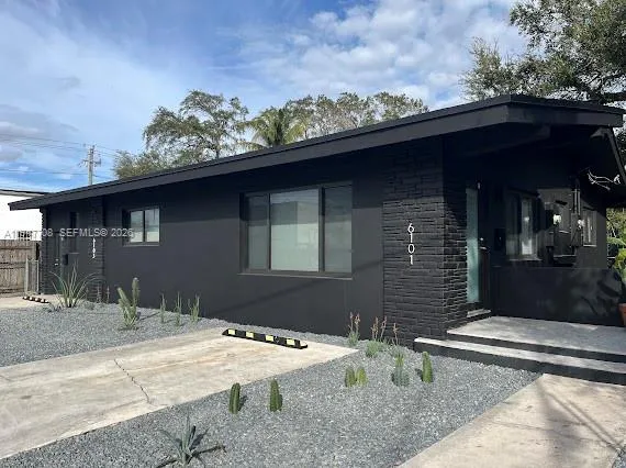 a backyard of a house with table and chairs