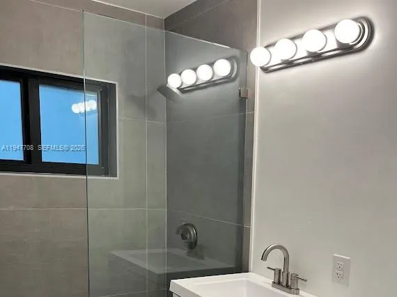a bathroom with a mirror and a shower