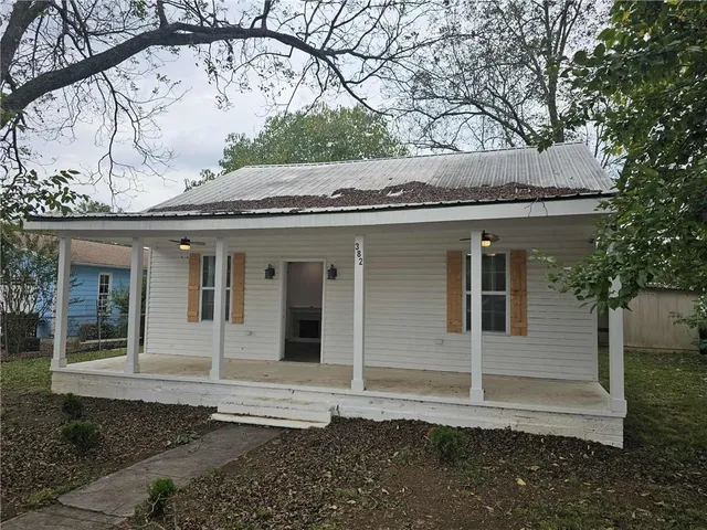 a front view of a house with a garden