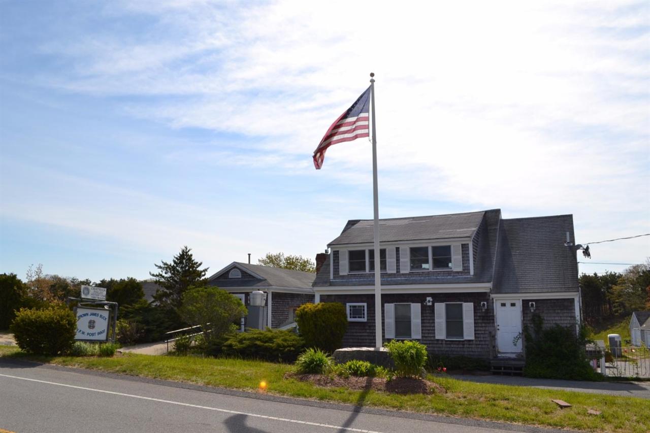 181 George Ryder Road Chatham, MA 02633 - Photo 23 of 24 a front view of a house with a garden and lake view