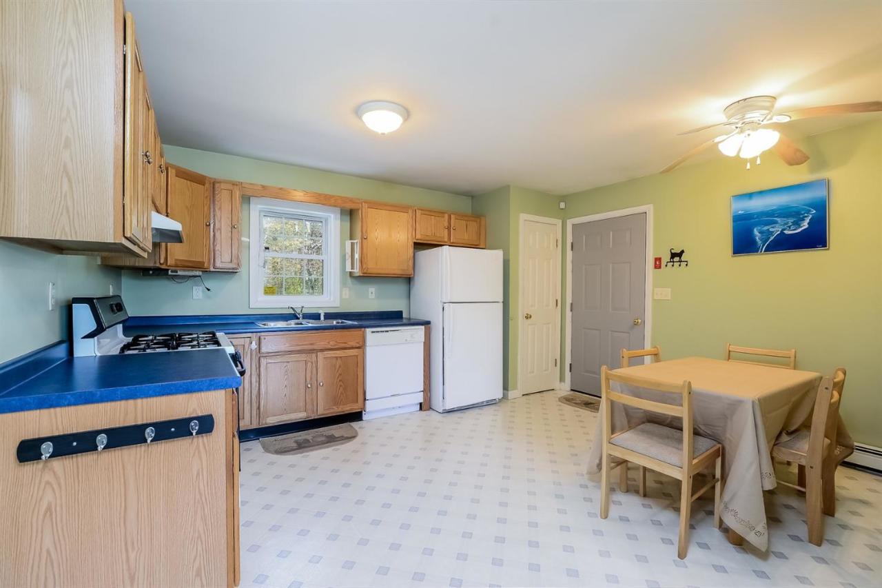 181 George Ryder Road Chatham, MA 02633 - Photo 5 of 24 a kitchen with a refrigerator and a stove top oven