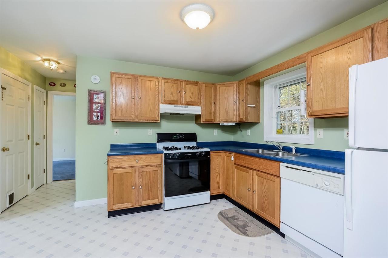 181 George Ryder Road Chatham, MA 02633 - Photo 6 of 24 a kitchen with stainless steel appliances granite countertop a stove a sink and a refrigerator