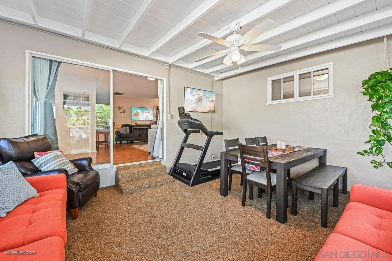 3726 Nassau Drive San Diego, CA 92115 - Photo 11 of 37 a living room with furniture a dining table and a bookshelf